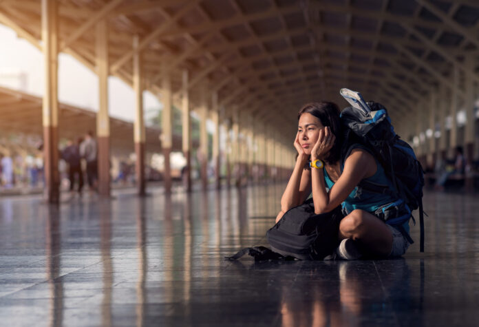 Asia,Woman,With,Bag,Backpack,And,Sitting,Bored,Wait,A